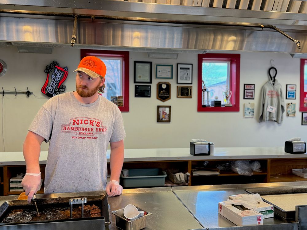 A grill cook working the counter in an open kitchen