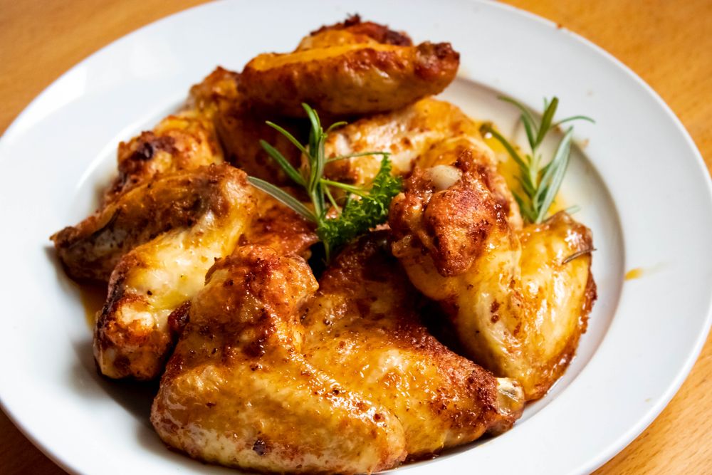 Charred grilled chicken pieces with herbs