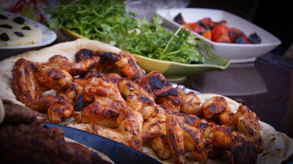 A tray of charred chicken pieces