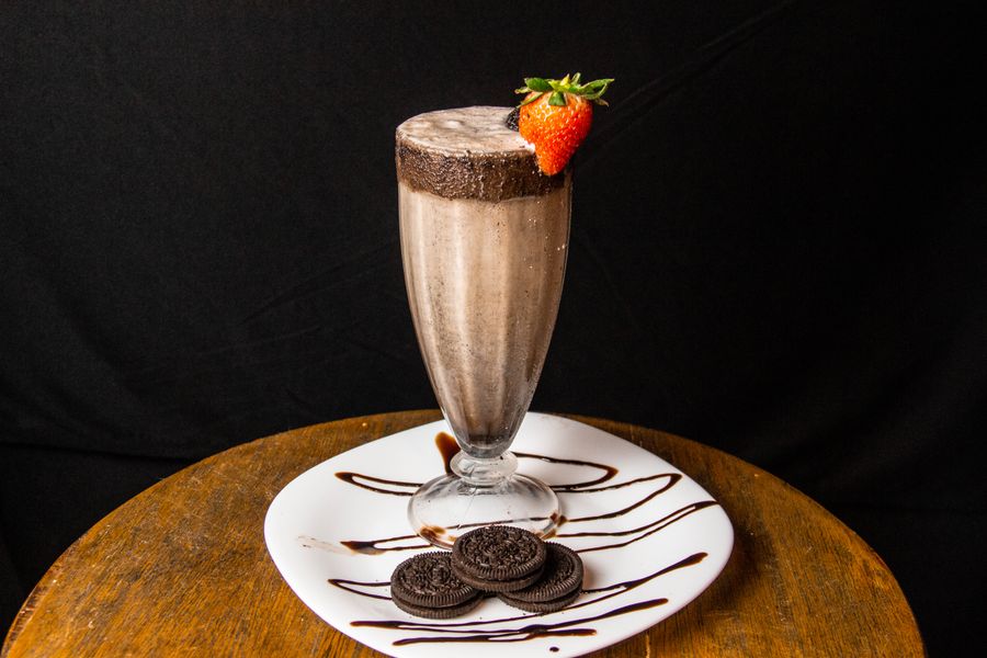 A thick chocolate milkshake topped with a strawberry