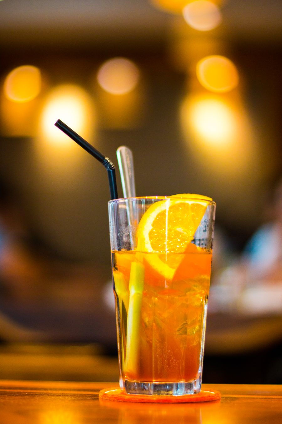 An iced orange soda with a slice of orange