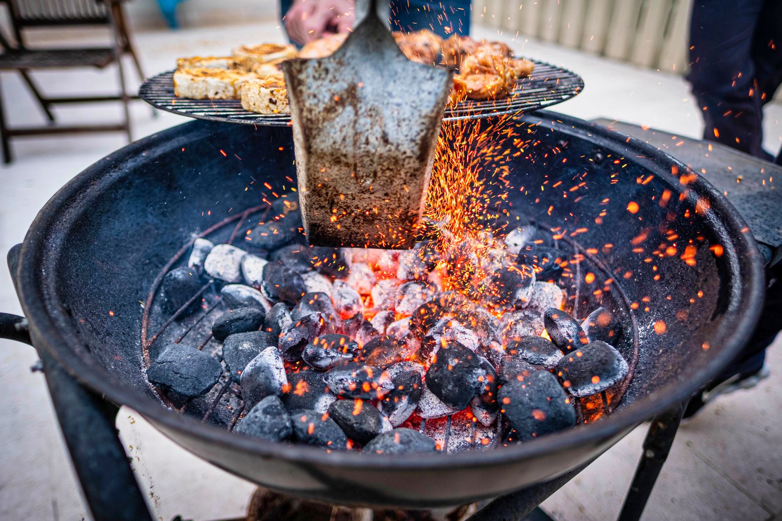 Sparks flying off a charcoal grill